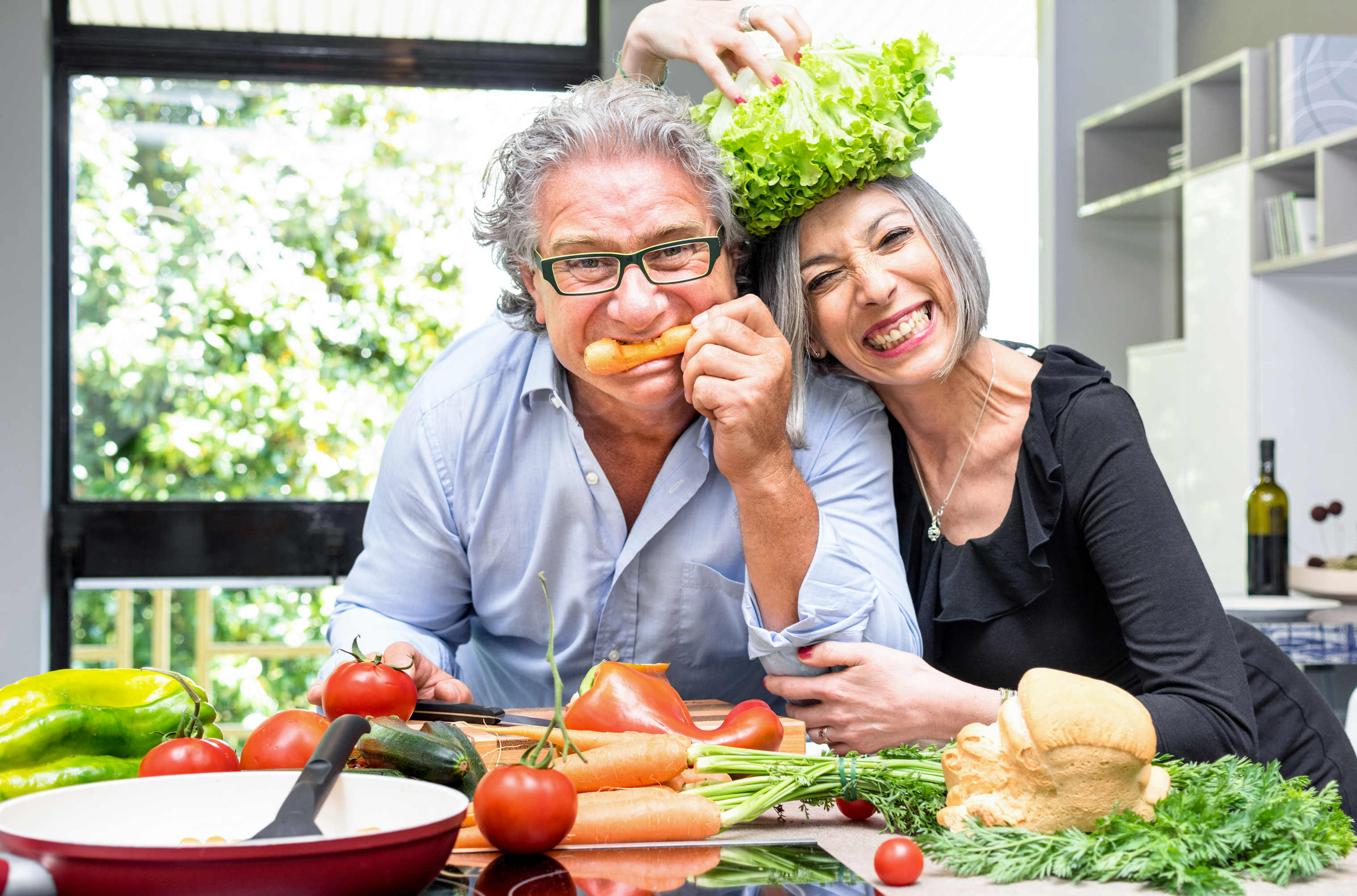 Senior Couple Having Fun In Kitchen With Healthy Food Retired